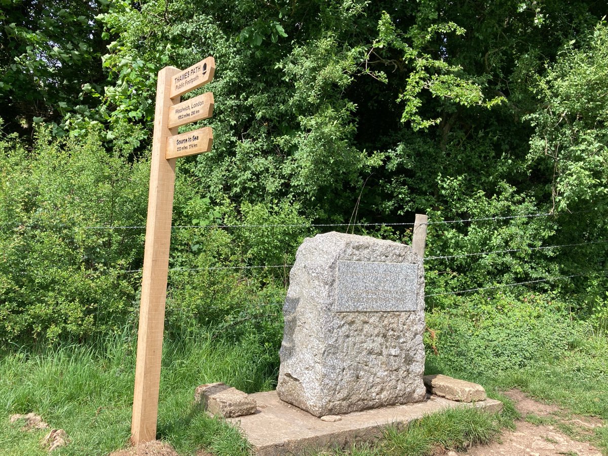 A sign post and a stone Description automatically generated