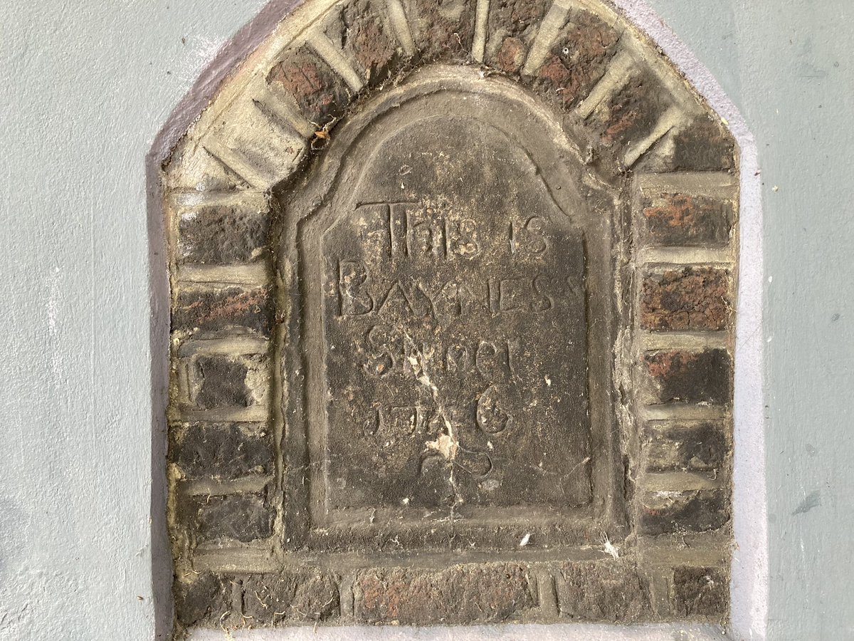 A stone plaque with writing on it Description automatically generated