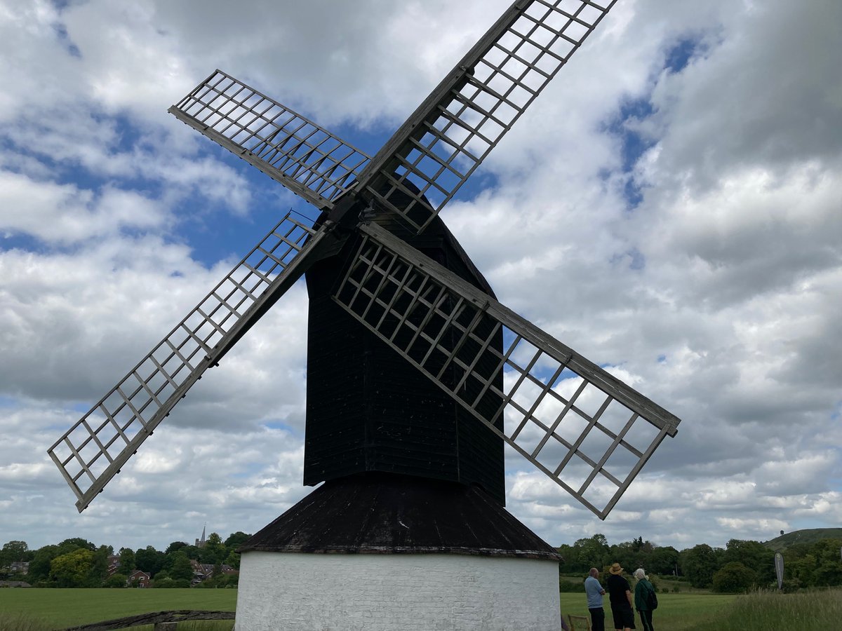 A windmill in a field Description automatically generated
